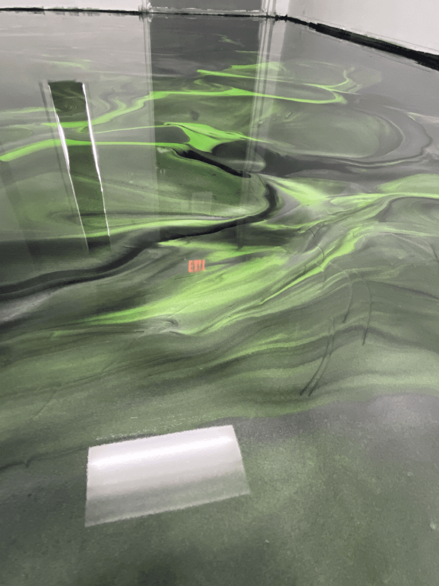 Metallic epoxy floor with flowing marble-like pattern